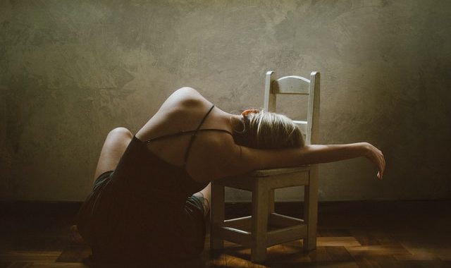 https://www.pexels.com/photo/woman-sitting-on-floor-while-leaning-on-chair-4217177/