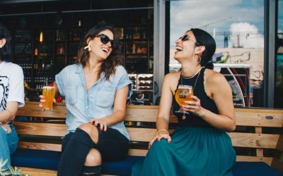 two-smiling-women-sitting-on-wooden-bench-1267696 two-smiling-women-sitting-on-wooden-bench-1267696