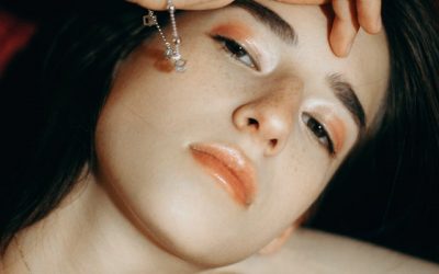 woman-in-a-black-top-and-jewelry-touching-her-forehead-2853198